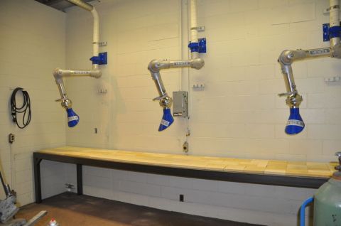 1996 Ford Bronco - Photograph of three articulated fume-extraction arms mounted above a workbench.