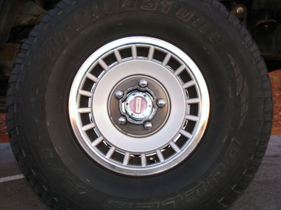Close-up of a Bridgestone tire and Ford Bronco wheel with a pink Ford logo.