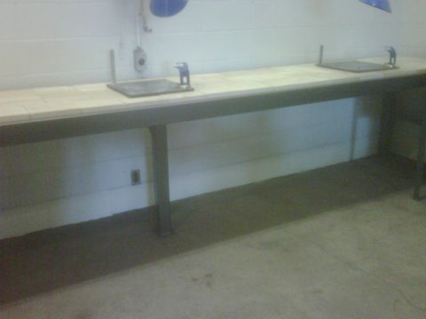 1996 Ford Bronco - Photograph of a long tile-topped bench with two stainless sinks in a shop or lab.