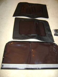 2008 Jeep Wrangler - Three black fabric panels with clear plastic windows are laid out on a carpeted surface. These appear to be soft top windows for a Jeep Wra…