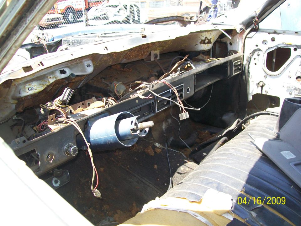 1972 Ford Ranchero interior, dashboard stripped, wires exposed, torn seat, rust visible
