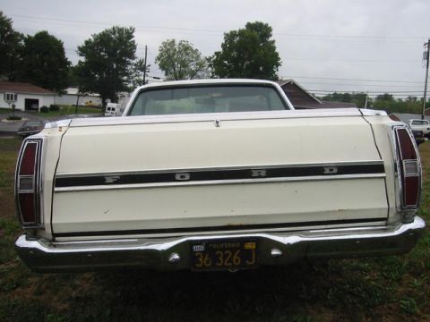 1971 Ford Ranchero - The rear of a white Ford Ranchero pickup truck is shown, its tailgate and chrome bumper.