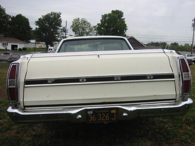 Rear of a cream Ford Ranchero with FORD tailgate lettering and California plate