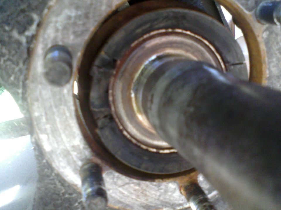 Close-up of a vehicle's wheel bearing assembly with some rust and wear