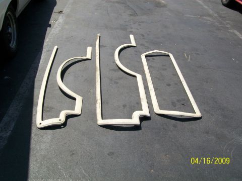 1972 Ford Ranchero - Several weatherstripping components are displayed on a dark asphalt surface.