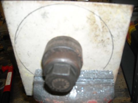 1979 Ford F-150 - A close-up view of a socket wrench secured in a vise, with a circular outline marked on a backing material.