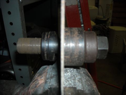 1979 Ford F-150 - Close-up of a bolt and nut assembly being held in a vise, likely for repair or fabrication.