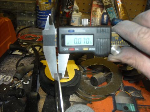 1979 Ford F-150 - A digital caliper is used to measure a metal component, showing a reading of 0.070 inches.