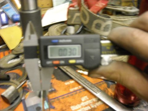 1979 Ford F-150 - A digital caliper is used to measure a part, displaying a reading of 0.030.