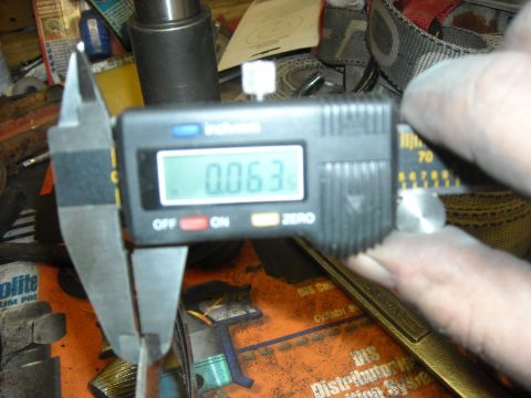 1979 Ford F-150 - Digital caliper reads 0.063 inches, indicating a precise measurement of a component.