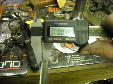 1979 Ford F-150 - A digital caliper is used to measure a component, showing a reading of 0.04R.