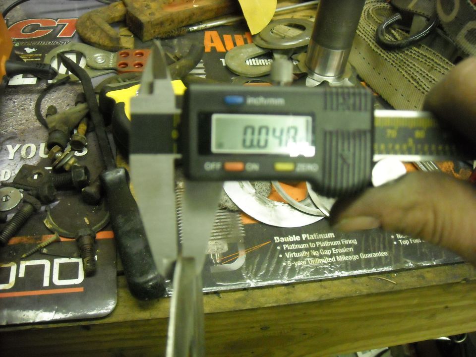 Digital caliper measuring a part, reading 0.04R