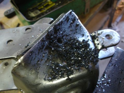 1995 Ford Taurus - Metal part with significant metal shavings, likely from machining or grinding.