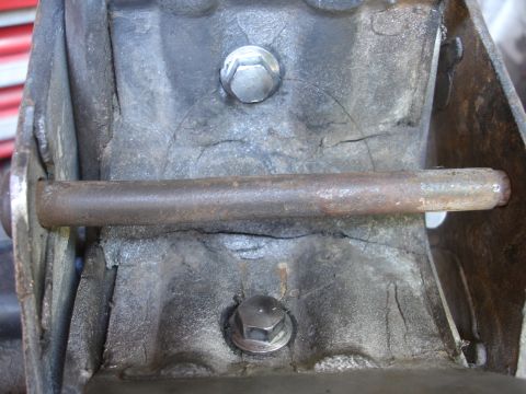 1995 Ford Taurus - Close-up view of a damaged engine mount, showing cracks in the metal and a protruding bolt.