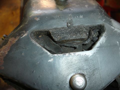 1995 Ford Taurus - This worn engine mount shows significant damage to its rubber component.