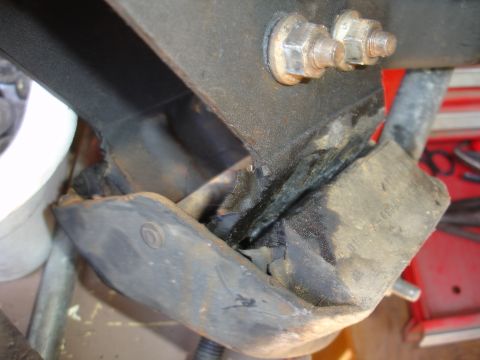 1995 Ford Taurus - Close-up of a damaged engine mount, showing cracked rubber and metal components.