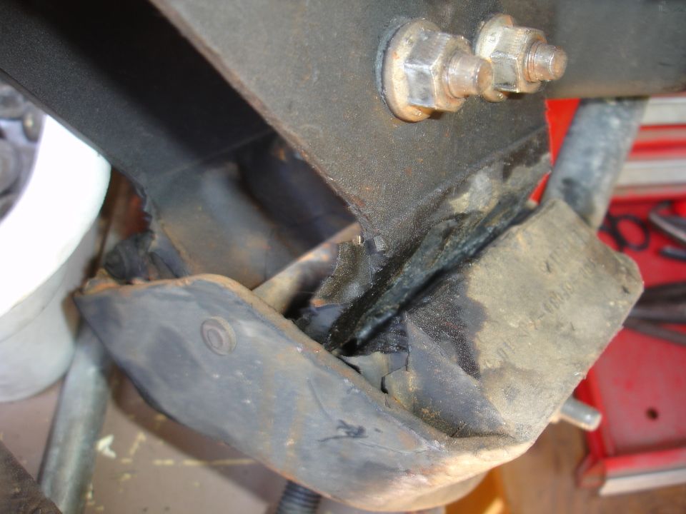 worn rubber engine mount with metal bracket and bolts