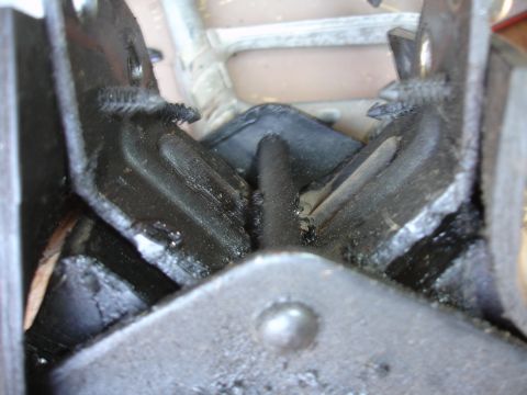 1995 Ford Taurus - This image shows a close-up view of a worn engine mount, highlighting the deteriorated rubber and metal parts.