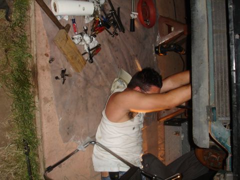 1995 Ford Taurus - A mechanic works on a vehicle part, surrounded by tools and supplies.