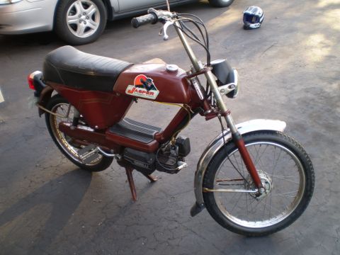 1981 Garelli Rally Sport - A vintage red moped with chrome accents and a distinctive Jasper decal is shown parked outdoors.