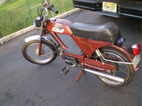 1981 Garelli Rally Sport - A red moped is parked on a driveway next to a black truck.