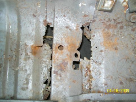 1972 Ford Ranchero - Close-up of heavily rusted metal, likely a vehicle floor pan, showing significant deterioration.