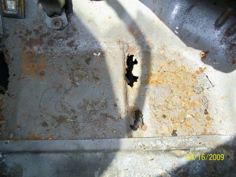 1972 Ford Ranchero - The floor pan of the vehicle is heavily rusted and has holes.