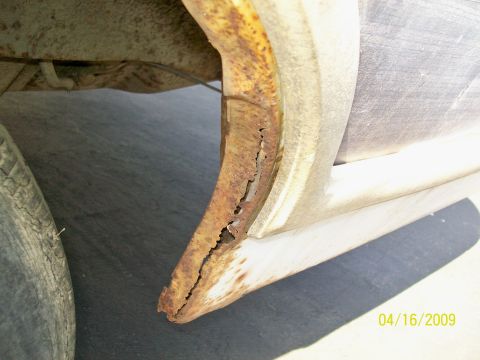 1972 Ford Ranchero - The image shows extensive rust damage in the wheel well area of a vehicle, with visible flaking metal and corrosion.