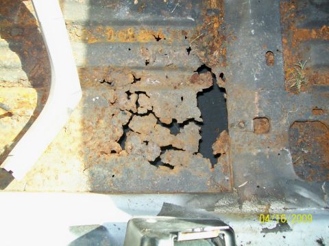 1972 Ford Ranchero - The floor pan shows significant rust damage and holes, indicating severe deterioration.