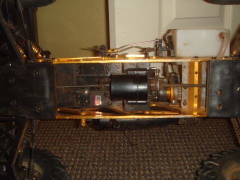 1992 Ford Bronco - Close-up view of the internal components of a remote control car chassis, showing the engine and suspension.