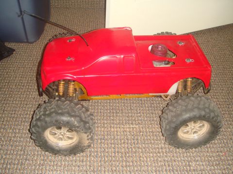 1992 Ford Bronco - This remote control monster truck features a bright red body and oversized off-road tires.