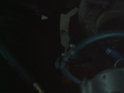 1989 Ford Bronco - Close-up view of engine bay components, including hoses and clamps.