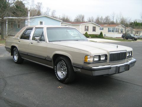 1988 Mercury Grand Marquis - This 1988 Mercury Grand Marquis has a two-tone paint scheme with a vinyl top and chrome wheels.