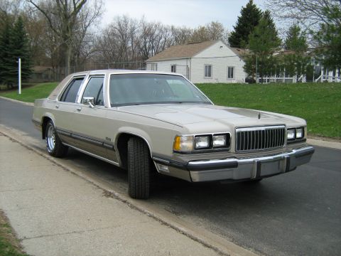 1988 Mercury Grand Marquis - This 1988 Mercury Grand Marquis is seen from a three-quarter front angle, parked on a street.