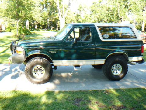 1992 Ford Bronco - This 1992 Ford Bronco is shown from the side, its green paint and off-road tires.