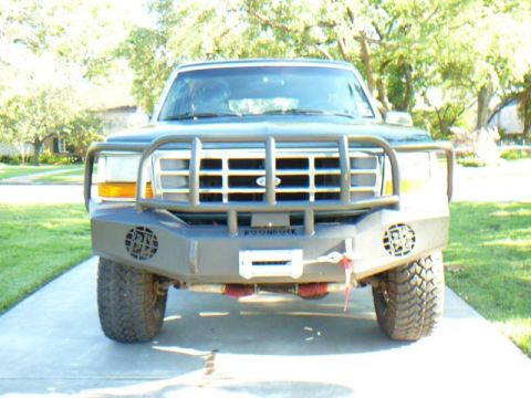 1992 Ford Bronco - This 1992 Ford Bronco features a heavy-duty aftermarket bumper with a winch and a robust grille guard.