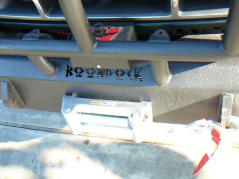 1992 Ford Bronco - Custom bumper with a winch and 'Bronco' cutouts is installed on a vehicle.