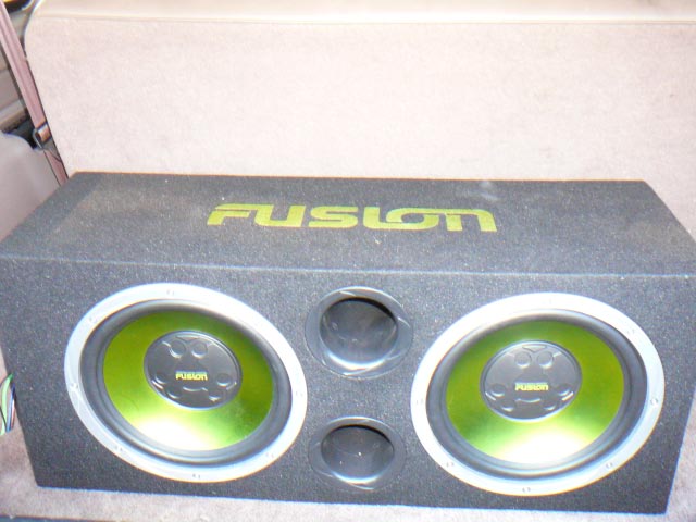 Car subwoofer with two green-cone speakers and 'FUSION' logo
