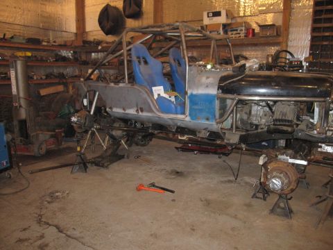 1992 Ford Bronco - This heavily modified vehicle is in a workshop, undergoing extensive customization and repair.