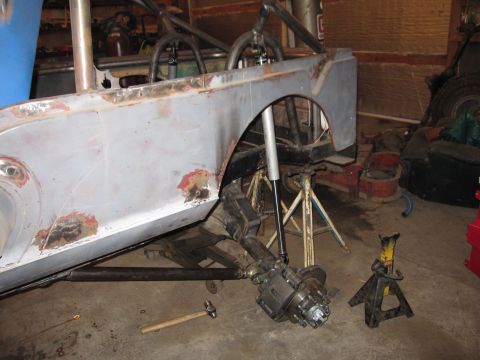 1992 Ford Bronco - This unfinished vehicle body is in a workshop, with its suspension and roll cage exposed, awaiting further work.