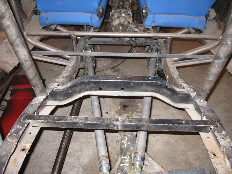 Customized vehicle frame with blue seats and exposed drivetrain components