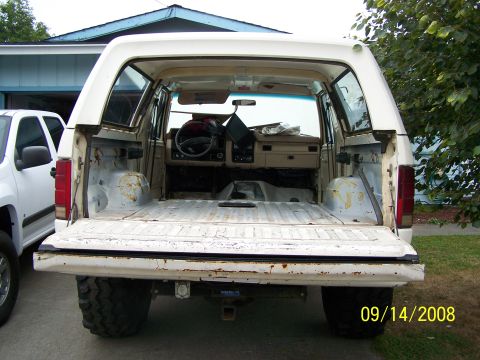 1982 Ford Bronco - Rear view of a 1982 Ford Bronco's interior, showing the cargo area and dashboard.