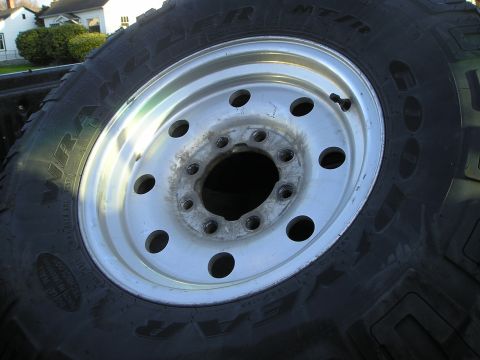 1997 Ford F-250 - A close-up view of a truck wheel and tire, with text visible on the tire sidewall.