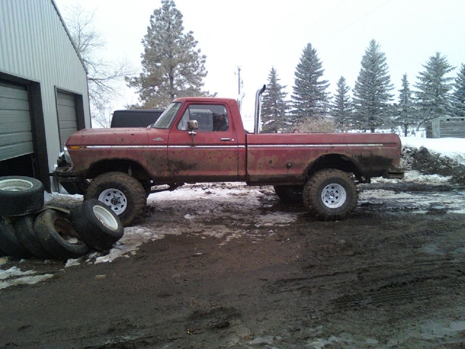 1978 Ford F-150 pickup truck parked next to a garage with snow on the ground