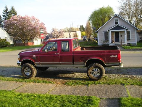 1997 Ford F-250 - This pickup truck is parked on the side of the road in front of a house.