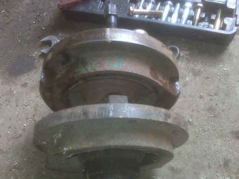 1995 Ford Bronco - A rusty brake drum assembly is shown with tools nearby, suggesting a repair or maintenance task.