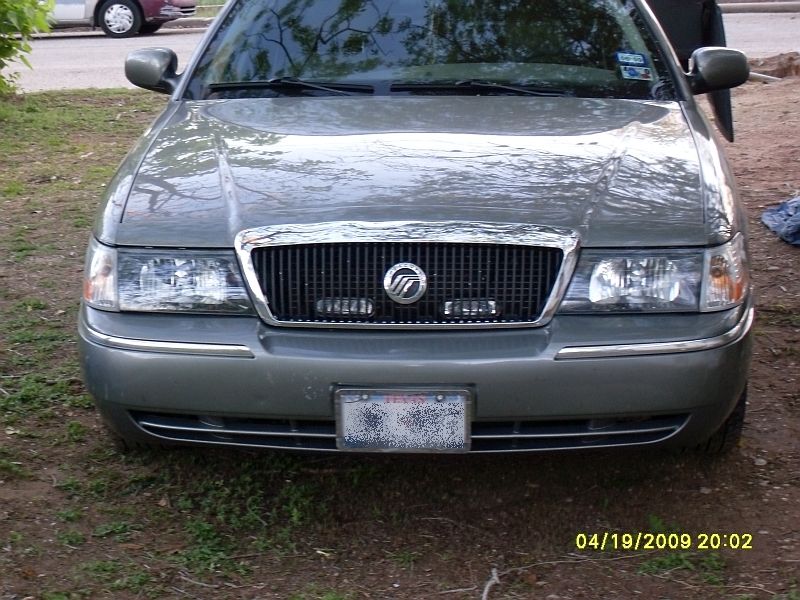 Front view of a gray Mercury Grand Marquis with a chrome grille and license plate
