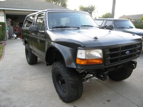 1986 Ford Bronco - This modified SUV features off-road tires and a custom front end, suggesting a build year in the early to mid-1990s.
