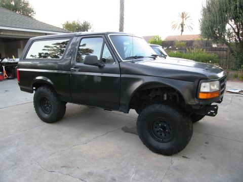 1986 Ford Bronco - This black Ford Bronco is modified with larger tires and suspension components.