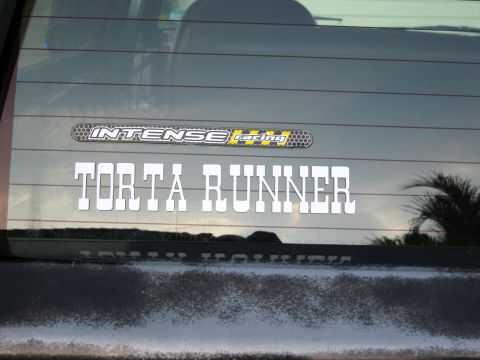 1986 Ford Bronco - Rear window decals include 'INTENSE racing' and 'TORTA RUNNER'.